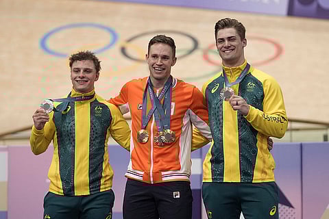 Paris Olympics Track Cycling men's keirin event: Harrie Lavreysen of Netherlands, centre, poses with the gold medals of the men's keirin event, flanked by silver medallists Matthew Richardson of Australia, left, and bronze medallist Matthew Glaetzer of Australia